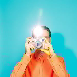 18729115_a-man-is-holding-a-vintage-film-camera-aimed-stra-9